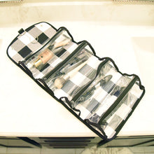 Load image into Gallery viewer, Lifestyle view of our Buffalo Check Roll Up Cosmetic Bag