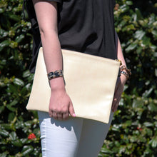 Load image into Gallery viewer, Lifestyle view of our Bamboo Tassel Pouch