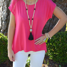 Load image into Gallery viewer, Lifestyle view of our Black Ceramic Bead Tassel Necklace