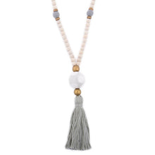 Load image into Gallery viewer, Natural wood bead necklace with gray tassel featuring a large ceramic bead in the center