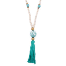 Load image into Gallery viewer, Natural wood bead necklace with turquoise tassel featuring a large ceramic bead in the center
