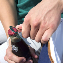 Load image into Gallery viewer, Bottle being opened with the bottle opener that comes with cooler bag