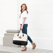 Load image into Gallery viewer, Lifestyle image of our Black Linen Duffle Bag