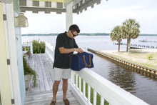 Load image into Gallery viewer, Young man searching inside his duffle bag