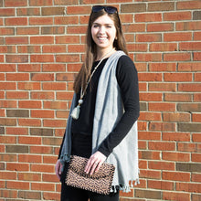 Load image into Gallery viewer, Model holding a Leopardista Black Whipstitch Clutch