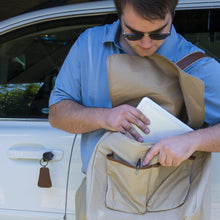 Load image into Gallery viewer, Young man inserting documents into his canvas messenger bag