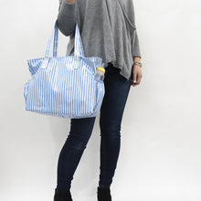 Load image into Gallery viewer, Lifestyle view of our Blue Stripe Vinyl Diaper Bag