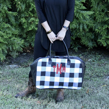 Load image into Gallery viewer, Lifestyle view of our Buffalo Check Duffle Bag
