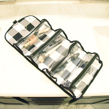 Load image into Gallery viewer, Lifestyle view of our Buffalo Check Roll Up Cosmetic Bag
