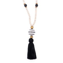 Load image into Gallery viewer, Natural wood bead necklace with black tassel featuring a large ceramic bead in the center
