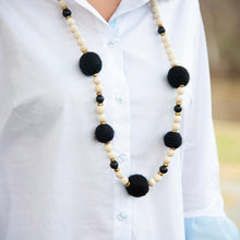 Load image into Gallery viewer, Lifestyle view of our Black Felt Bead Necklace
