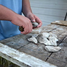 Load image into Gallery viewer, Man opening an oyster with the knife
