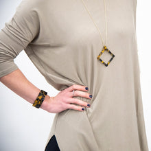 Load image into Gallery viewer, Lifestyle view of our Tortoise Square Frame Necklace
