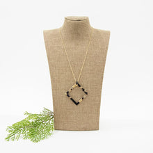 Load image into Gallery viewer, Lifestyle view of our Square Frame Blonde Tortoise Shape Necklace
